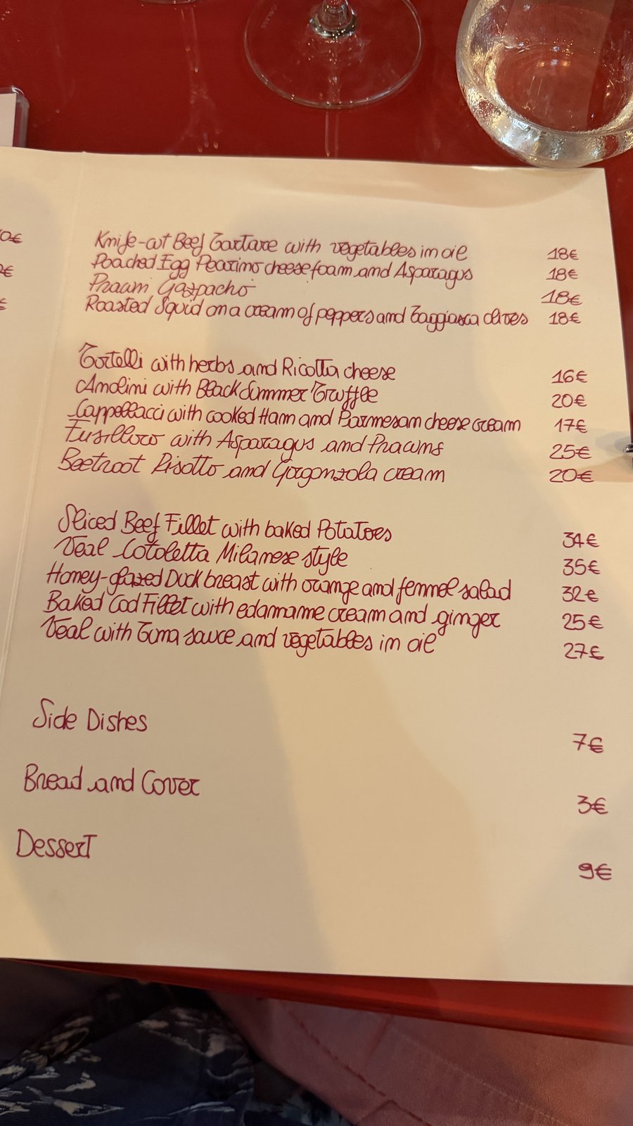 A handwritten Italian restaurant menu, mains and prices in euros — photographed on the trip, AI Super Simplified